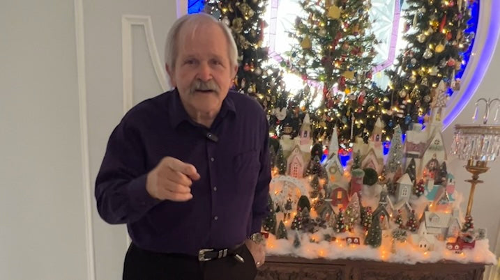 Jim Shore standing by Christmas wreath