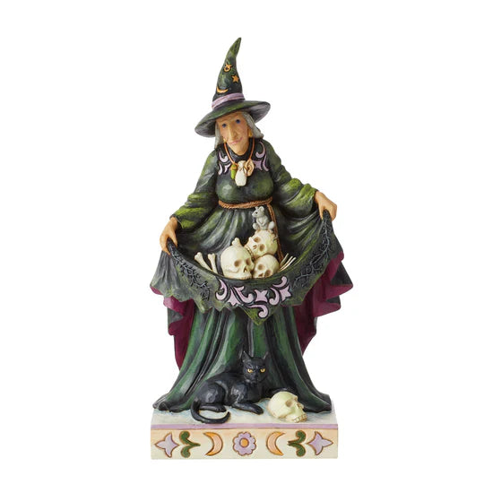 Witch holding skulls figurine