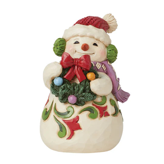 Snowman holding wreath figurine